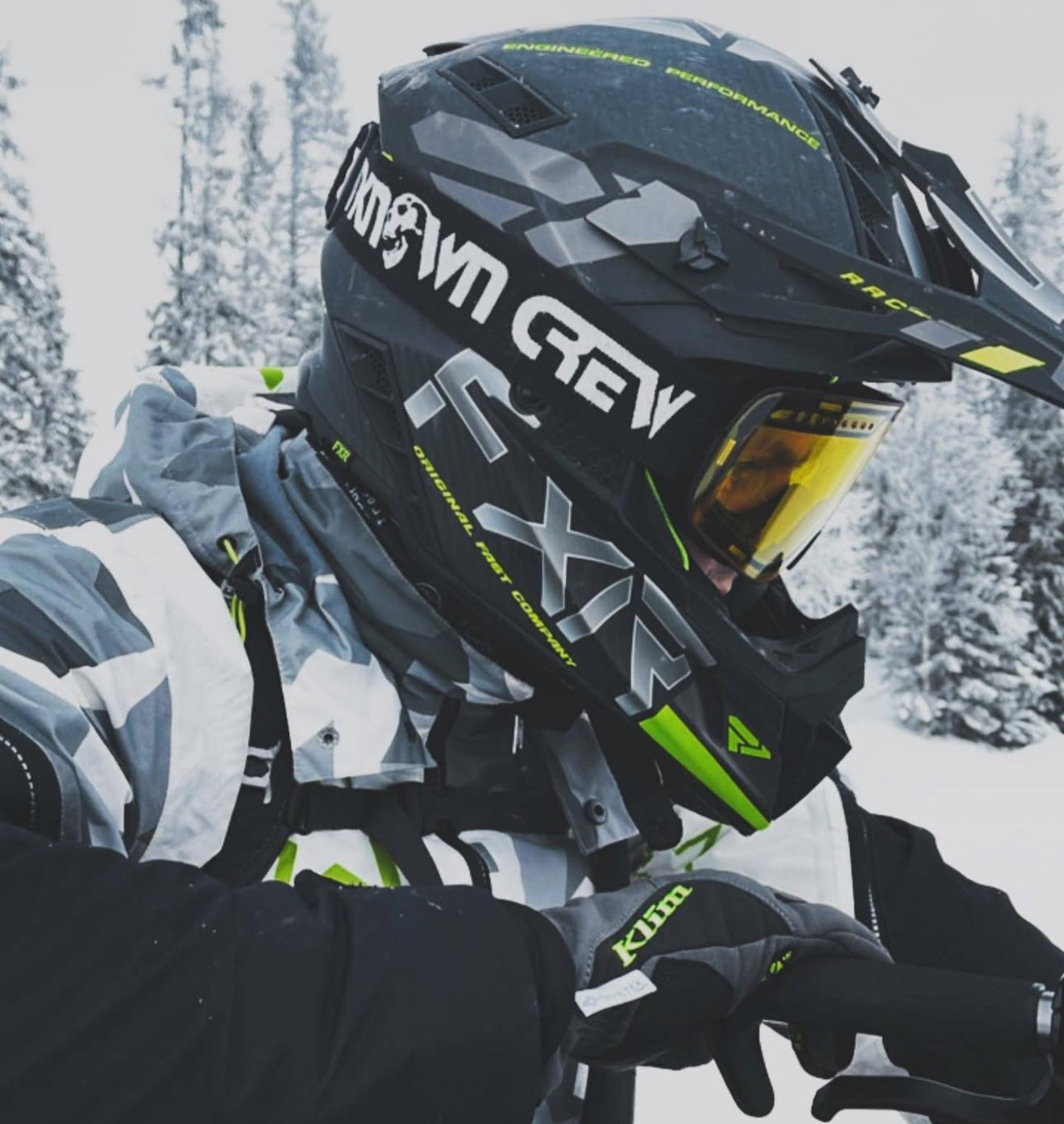 Person wearing a black helmet with visible branding in a snowy outdoor setting